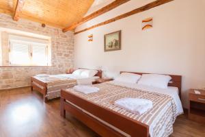a bedroom with two beds and a window at Apartment Janet in Luka