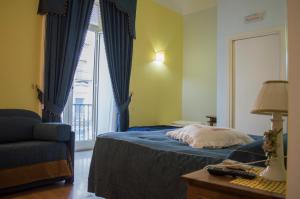 ナポリにあるB＆B　ボナパセ　ポルタノラナのベッドルーム1室(ベッド1台、ソファ、窓付)