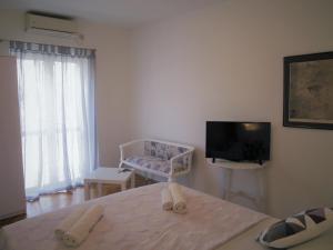 a living room with a tv and a chair at Apartment Ilko in Dubrovnik
