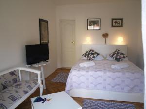 a bedroom with a bed and a flat screen tv at Apartment Ilko in Dubrovnik