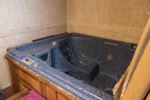 a large blue tub in a corner of a room at Luna del Valle in Nueva de Llanes