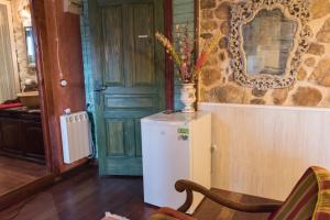 a kitchen with a refrigerator and a vase with flowers on it at Luna del Valle in Nueva de Llanes