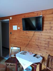 a room with a table and a tv on a wall at Pirates Hotel in Hainburg an der Donau