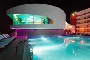 a swimming pool at a hotel at night at Zenith - Top Country Line - Conference & Spa Hotel in Mamaia