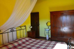 a bedroom with a bed with a checkered blanket at Casale Poggio Colpiccione in Passignano sul Trasimeno