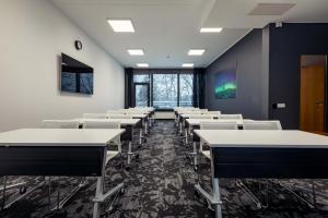 an empty room with desks and chairs in it at GMP Clubhotel Apartments in Otepää