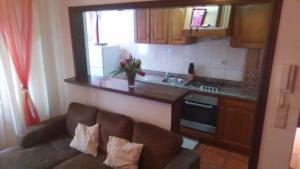 a living room with a couch in front of a kitchen at seiaalojamentos in Seia