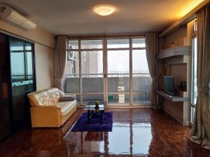 a living room with a couch and a large window at 21C Riviera Up Condominium in Pak Kret
