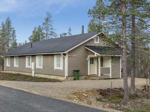a small house with a driveway in front of it at North Frontier 2-bedroom cabin in Saariselka +10 photos
