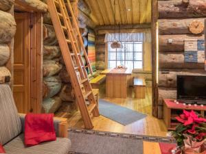 a living room with a staircase in a log cabin at Holiday Home Mäntylä a-osa by Interhome in Nissi