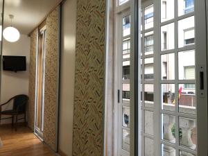 pasillo con puertas correderas de cristal y ventana en Hotel del Mar Vigo, en Vigo