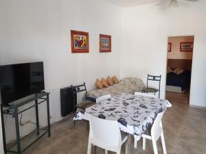 a living room with a table and a couch at Aguamarina in Las Grutas
