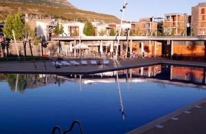 a large pool of blue water in a city at Apartamento en c/ Peroneros in Latas