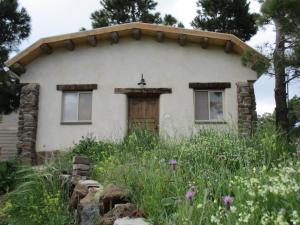 a house with a garden in front of it at Earth Zimmer El Rom in El-Rom