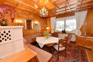 a living room with a table and a couch at Landhaus Fuchsenstube in Schruns