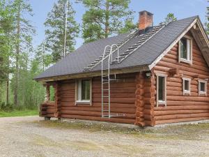 a log cabin with a roof and a ladder on it at Holiday Home Jäkälä by Interhome in Kyrö