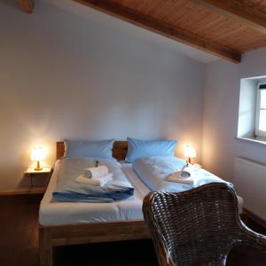 two beds in a room with two lamps on them at Pension Redefin in Redefin