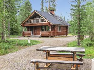 a log cabin with a picnic bench in front of it at Holiday Home Jäkälä by Interhome in Kyrö