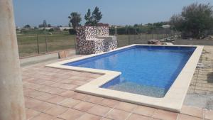 a swimming pool in a yard next to a fence at casarosana in Deltebre