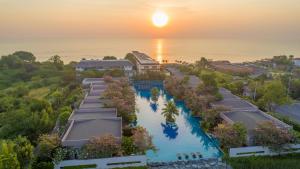 an aerial view of the resort at sunset at Avani+ Hua Hin Resort in Cha Am