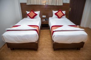 Łóżko lub łóżka w pokoju w obiekcie Hotel Himalayan Vacation
