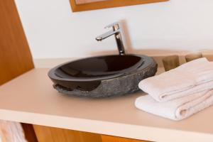 a black sink on a counter in a bathroom at Obere Gasse 11 in Saas-Fee +8 photos