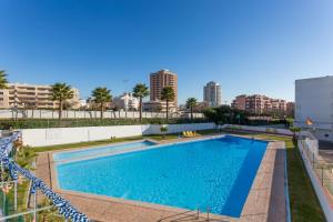 a large swimming pool in the middle of a city at Edifício Rocha Vau Beach Apartment in Portimão