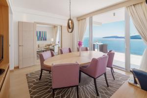 a dining room with a table and chairs at Sun Gardens Dubrovnik in Dubrovnik