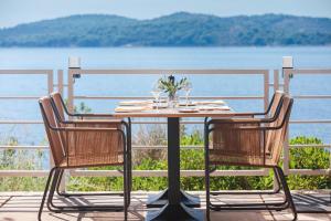 a table and chairs with a view of the water at Sun Gardens Dubrovnik in Dubrovnik