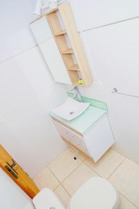 a bathroom with a toilet and a sink at Palmas del Caribe in Punta Del Diablo +47 photos