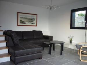 a living room with a couch and a table at La Maison De La Rade in Le Relecq-Kerhuon