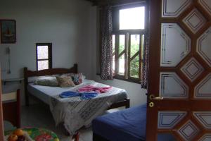 Postel nebo postele na pokoji v ubytování Pousada Revoada dos Papagaios