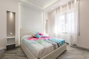 A bed or beds in a room at La Fiaba Roma Apartment