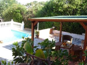 a patio with a gazebo and a swimming pool at Villa Denia in Denia