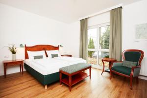 En eller flere senge i et værelse på Hotel Prinzregent München Messe