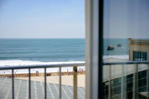 a view of the beach from the balcony of a condo at Hôtel Le Windsor Biarritz in Biarritz