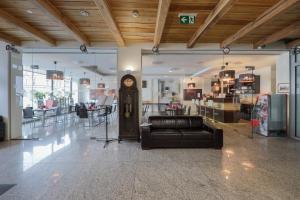 a lobby with a clock in the middle of a store at Kamienica Pod Aniołami in Wrocław