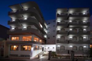 a tall white building at night at Galaxy Hotel in Ierapetra