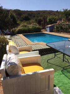 una piscina con almohadas y una mesa junto a ella en Parcela Los Castaños, en Concón