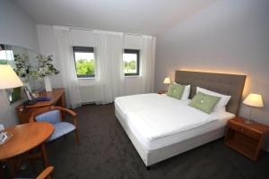 Postel nebo postele na pokoji v ubytování Hotel Moritz an der Elbe