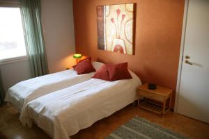 Villa Prud في كوبيو: غرفة نوم بسريرين ولوحة على الحائط