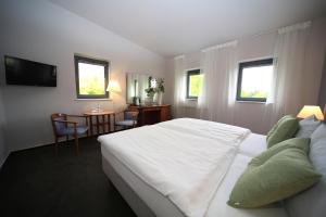 Postel nebo postele na pokoji v ubytování Hotel Moritz an der Elbe