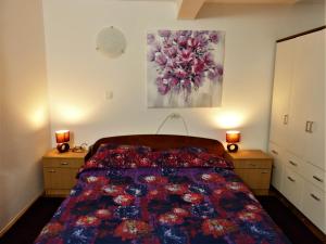 a bedroom with a bed and two night stands at Apartman La Linea - Free parking in Zagreb