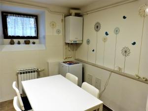 a kitchen with a white table and a table and chairs at Apartman La Linea - Free parking in Zagreb
