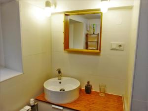 a bathroom with a white sink and a mirror at Apartman La Linea - Free parking in Zagreb