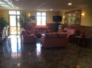 a living room with couches and tables and windows at Hotel Sonia Chipude in El Cercado