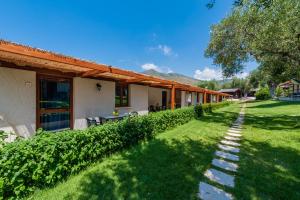 a house with a pathway leading to a yard at Green Village in Marina di Camerota