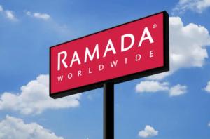 a red sign that reads ramada world wide at Ramada by Wyndham Beaver Falls in Beaver Falls