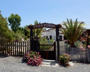 a gate to a hotel with flowers in front of it at Finca Florida in San Miguel de Abona