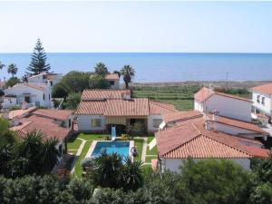 a group of houses with a swimming pool and the ocean at El Hidalgo Costa del Sol in Torre de Benagalbón